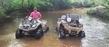 Driving through the river in an ATV at Creekside Offroad Ranch